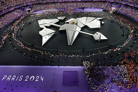 Flag bearers surround the stage during the 2024 Summer Olympics closing ceremony
